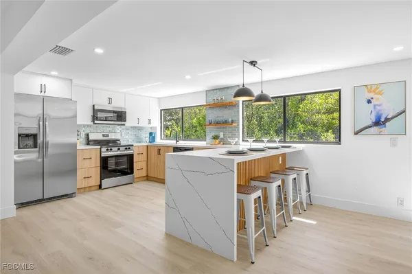 a kitchen with stainless steel appliances granite countertop a stove and a refrigerator