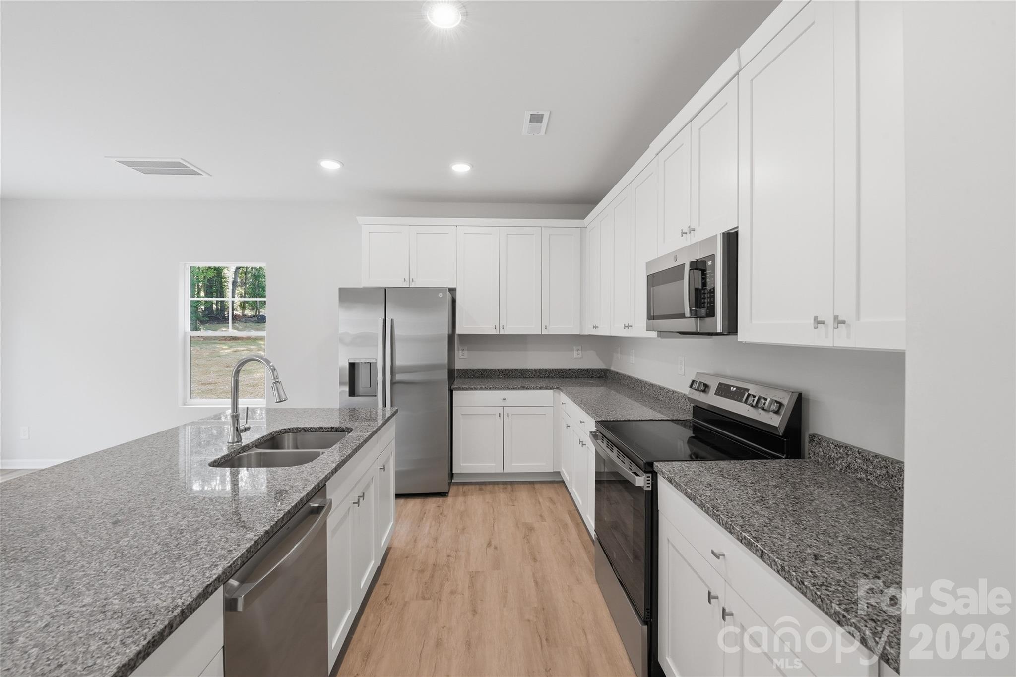 242 Landers Chapel Road Lincolnton, NC 28092 - Photo 2 of 33 a kitchen with granite countertop a sink stove and refrigerator