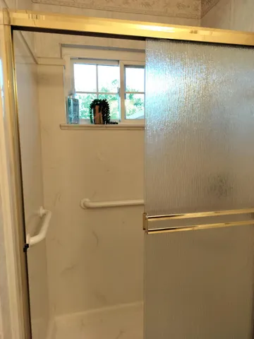 a bathroom with a shower and a sink