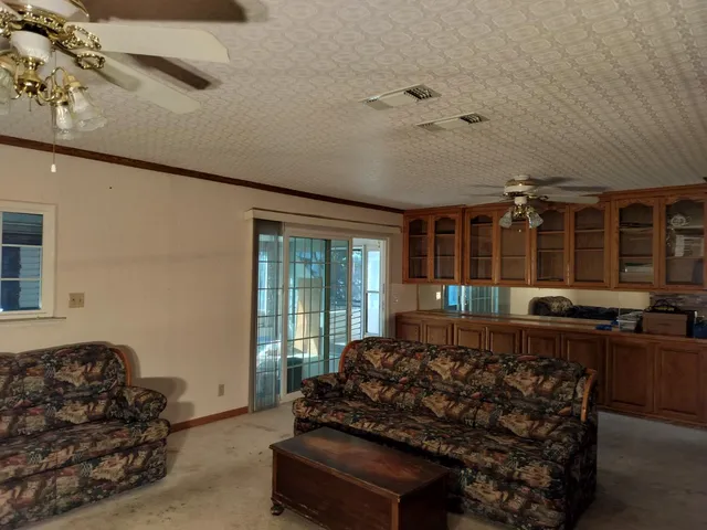 a bedroom with furniture and a ceiling fan