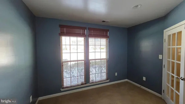 a kitchen with stainless steel appliances granite countertop a refrigerator a stove top oven a sink dishwasher a refrigerator and white cabinets with wooden floor