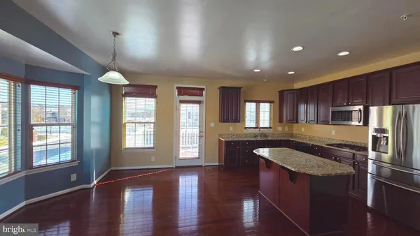 a kitchen with center island table and chairs in it