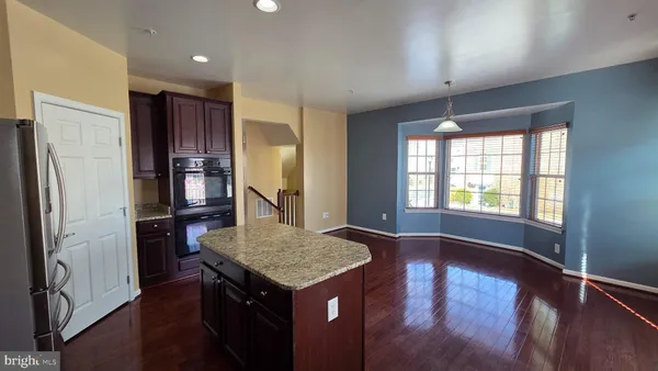 a kitchen with sink table and chairs