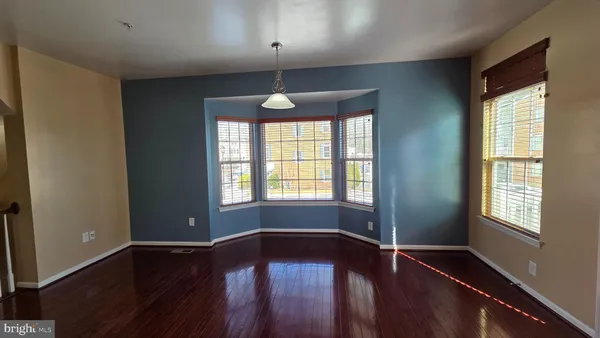 a view of a room with wooden floor