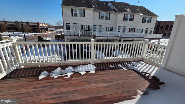a living room with furniture a wooden floor and a chandelier