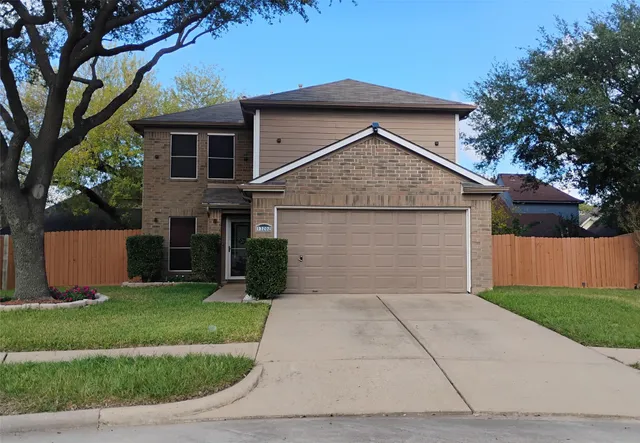 a front view of house with yard and garage