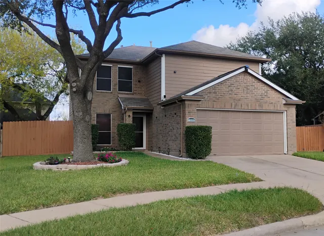 a view of a house with a yard and tree s