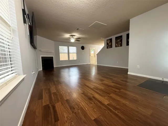 wooden floor in an empty room with a window