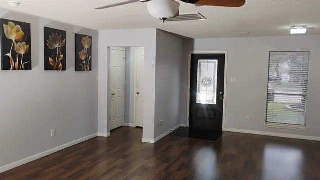 wooden floor in an empty room with a window