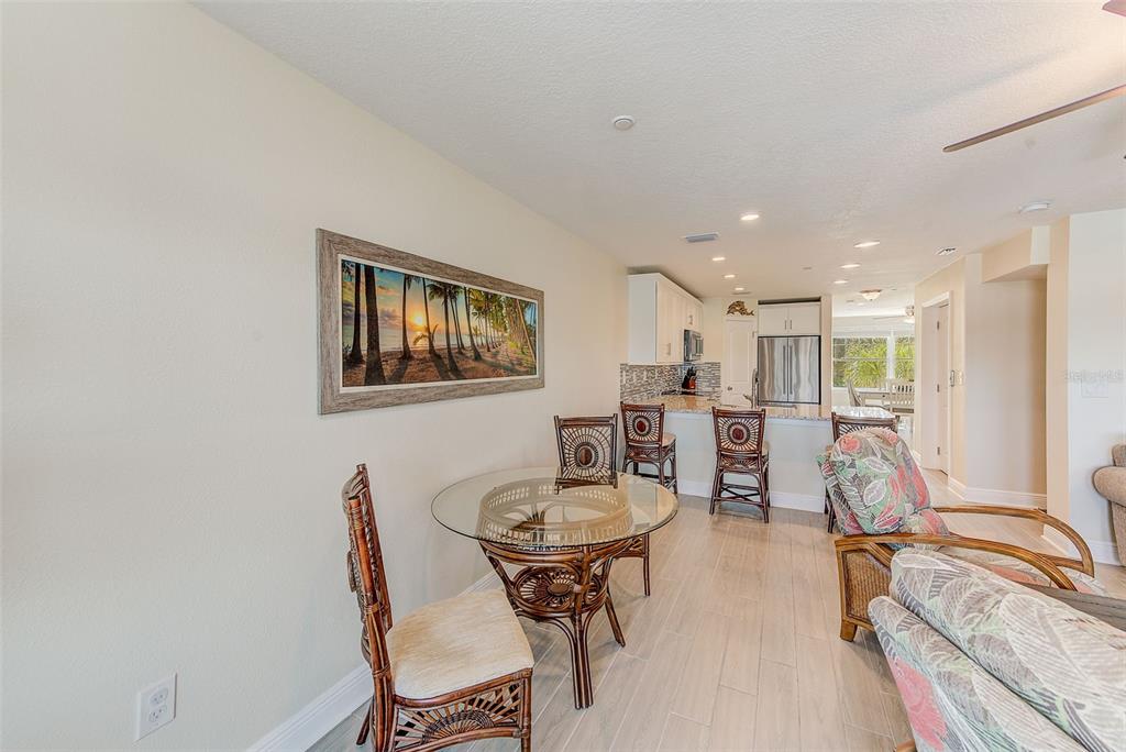 100 Windrush Boulevard, Unit 2 Indian Rocks Beach, FL 33785 - Photo 20 of 73 a view of a dining room with furniture and a table