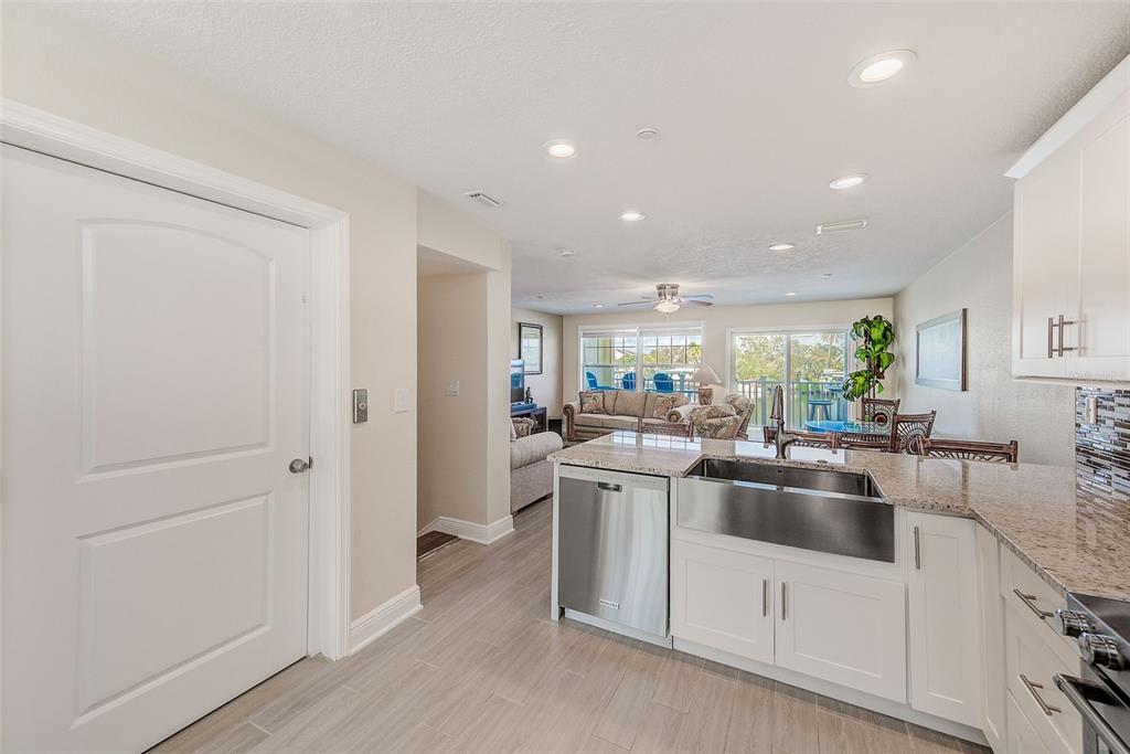 100 Windrush Boulevard, Unit 2 Indian Rocks Beach, FL 33785 - Photo 22 of 73 a kitchen with stainless steel appliances a sink and a refrigerator