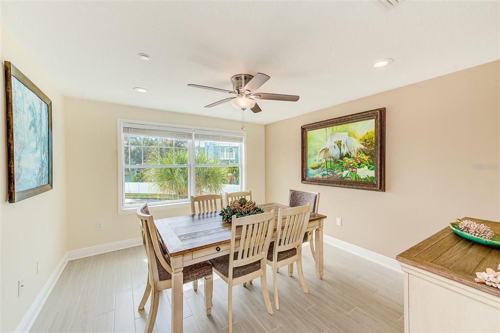 100 Windrush Boulevard, Unit 2 Indian Rocks Beach, FL 33785 - Photo 26 of 73 a dining room with furniture and window