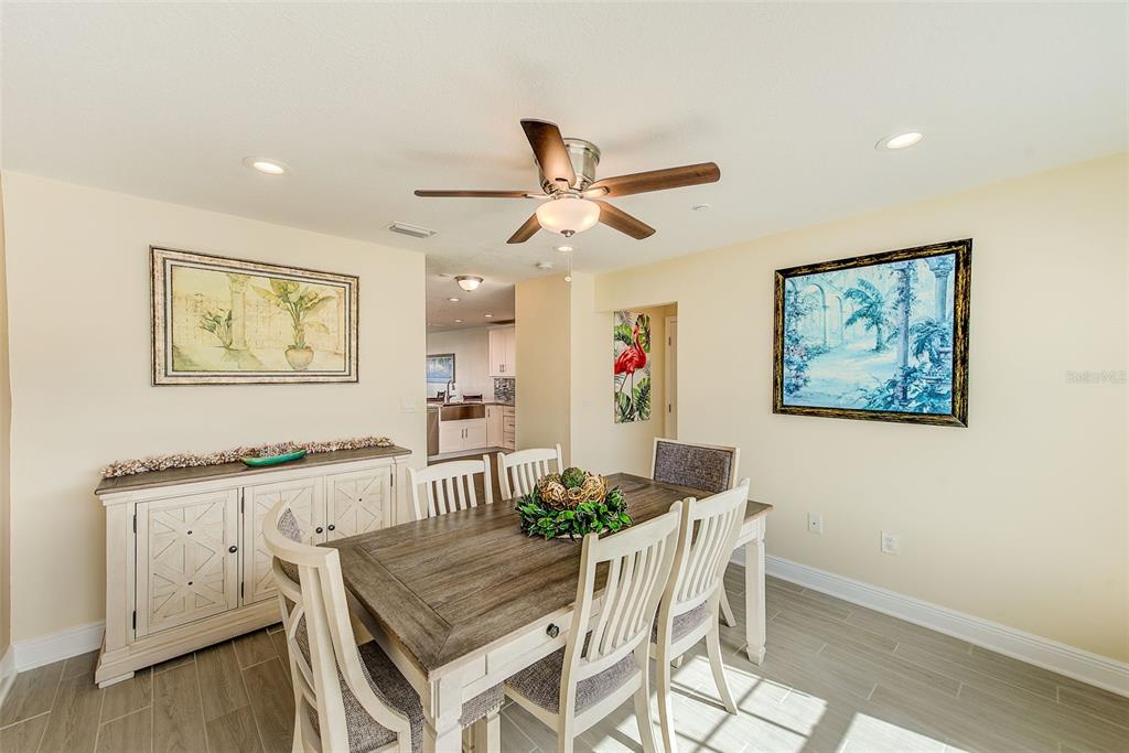 100 Windrush Boulevard, Unit 2 Indian Rocks Beach, FL 33785 - Photo 27 of 73 a view of a dining room with furniture and wooden floor