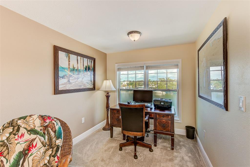 100 Windrush Boulevard, Unit 2 Indian Rocks Beach, FL 33785 - Photo 32 of 73 a view of a workspace with furniture and a window