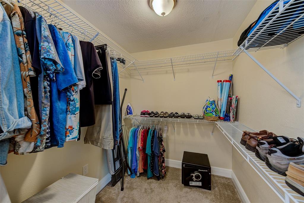 100 Windrush Boulevard, Unit 2 Indian Rocks Beach, FL 33785 - Photo 36 of 73 a view of walk in closet with clothes and shoes