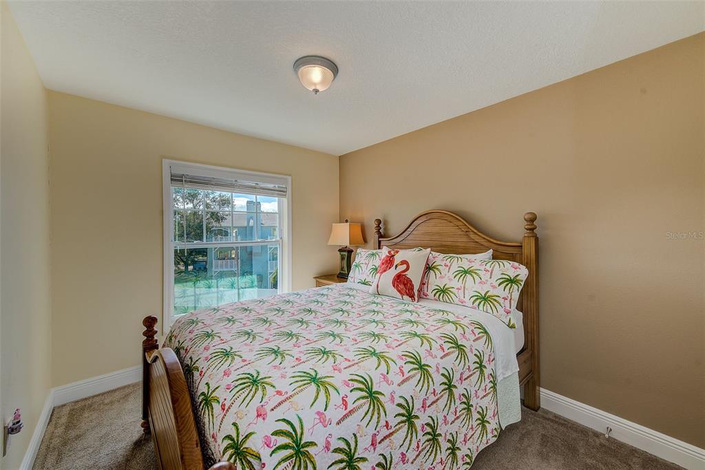 100 Windrush Boulevard, Unit 2 Indian Rocks Beach, FL 33785 - Photo 38 of 73 a bedroom with a bed and a window