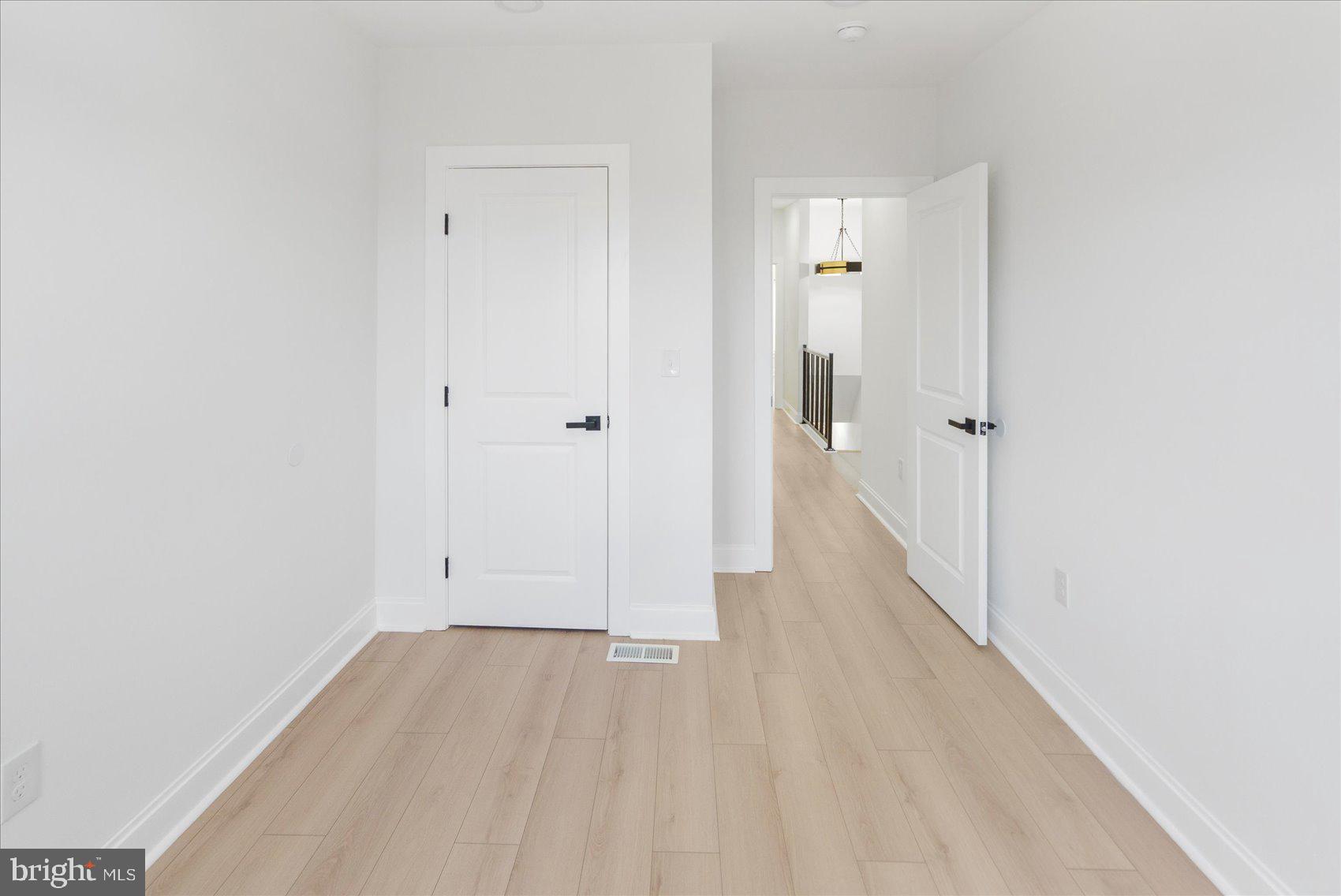 2422 East Biddle Street Baltimore, MD 21213 - Photo 19 of 27 a view of a hallway with wooden floor
