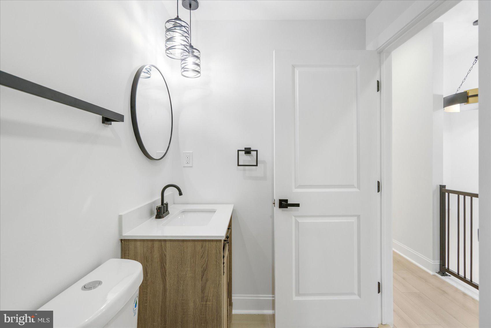 2422 East Biddle Street Baltimore, MD 21213 - Photo 23 of 27 a bathroom with a sink a toilet and shower