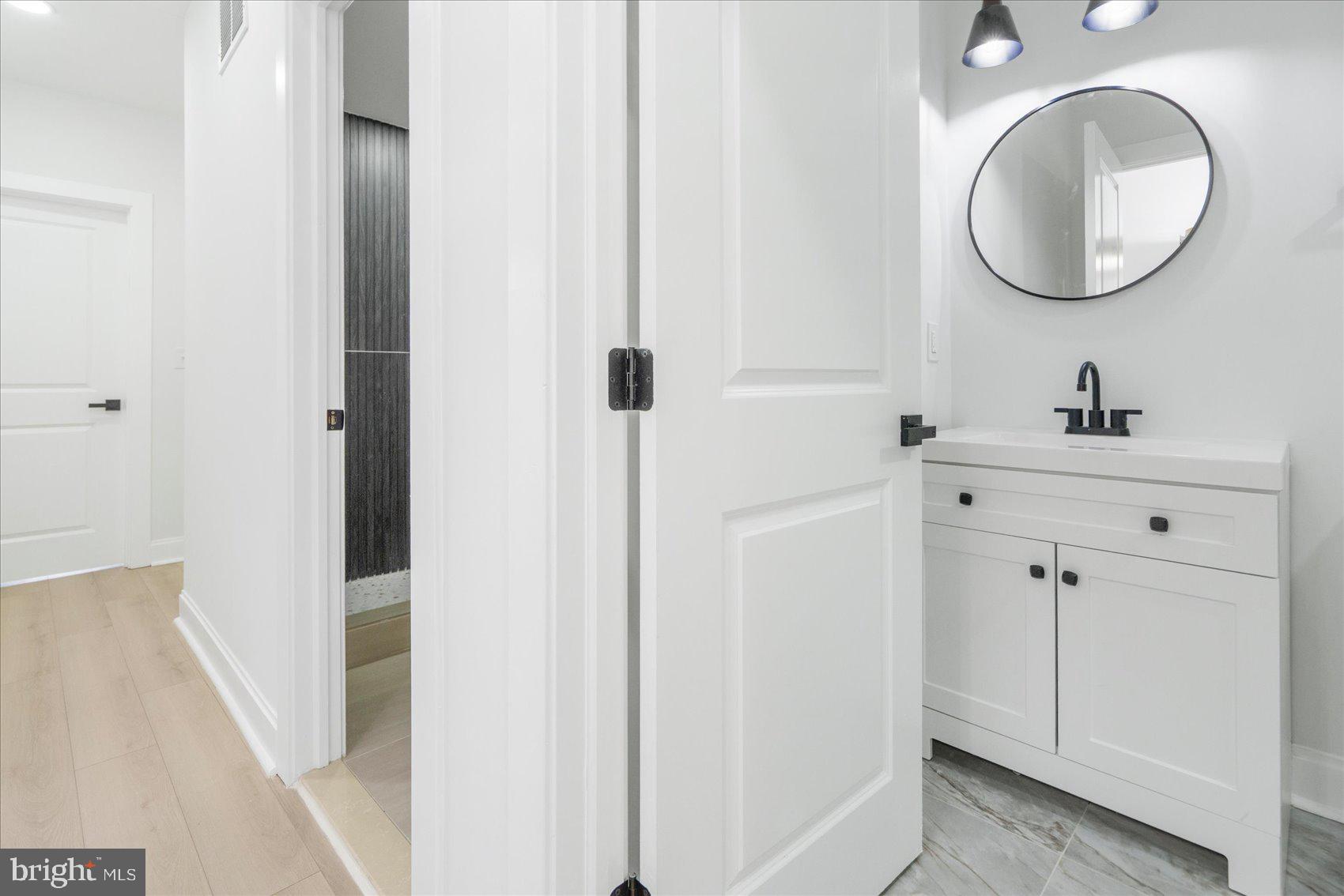 2422 East Biddle Street Baltimore, MD 21213 - Photo 24 of 27 a bathroom with a sink and a mirror
