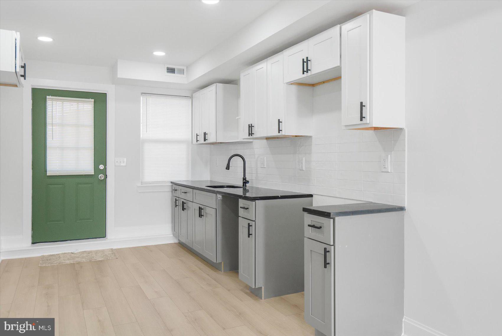 2422 East Biddle Street Baltimore, MD 21213 - Photo 6 of 27 a kitchen with stainless steel appliances granite countertop a sink stove and refrigerator