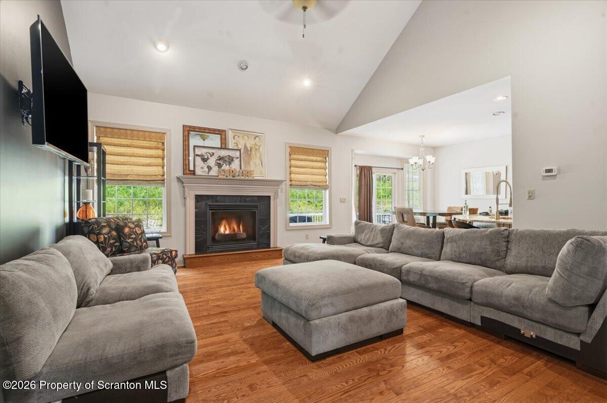 99 Hilltop Road Waverly, PA 18471 - Photo 5 of 41 a living room with furniture a large window and a fireplace