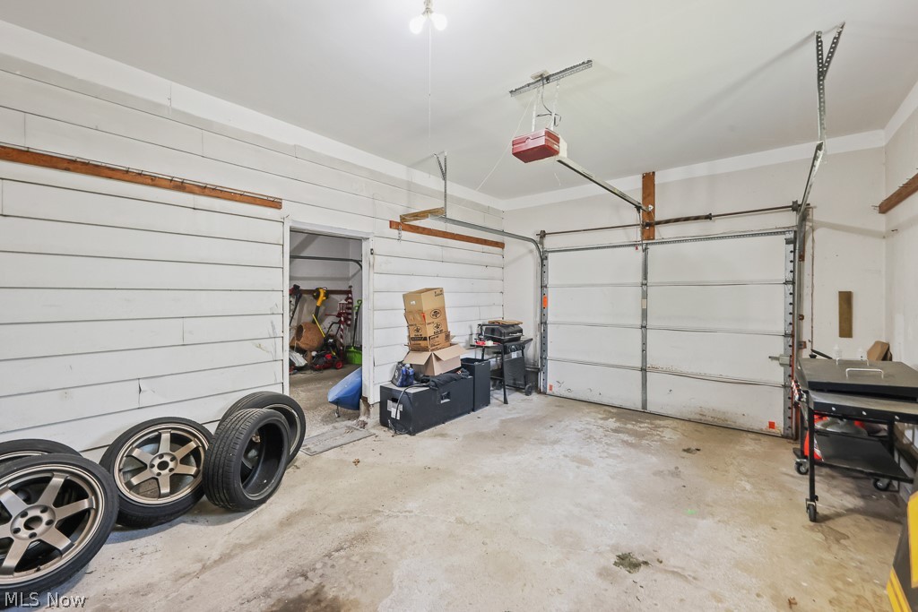 611 Herbert Road Akron, OH 44312 - Photo 29 of 30 Spacious garage featuring a concrete floor, overhead lighting, and an automatic garage door opener