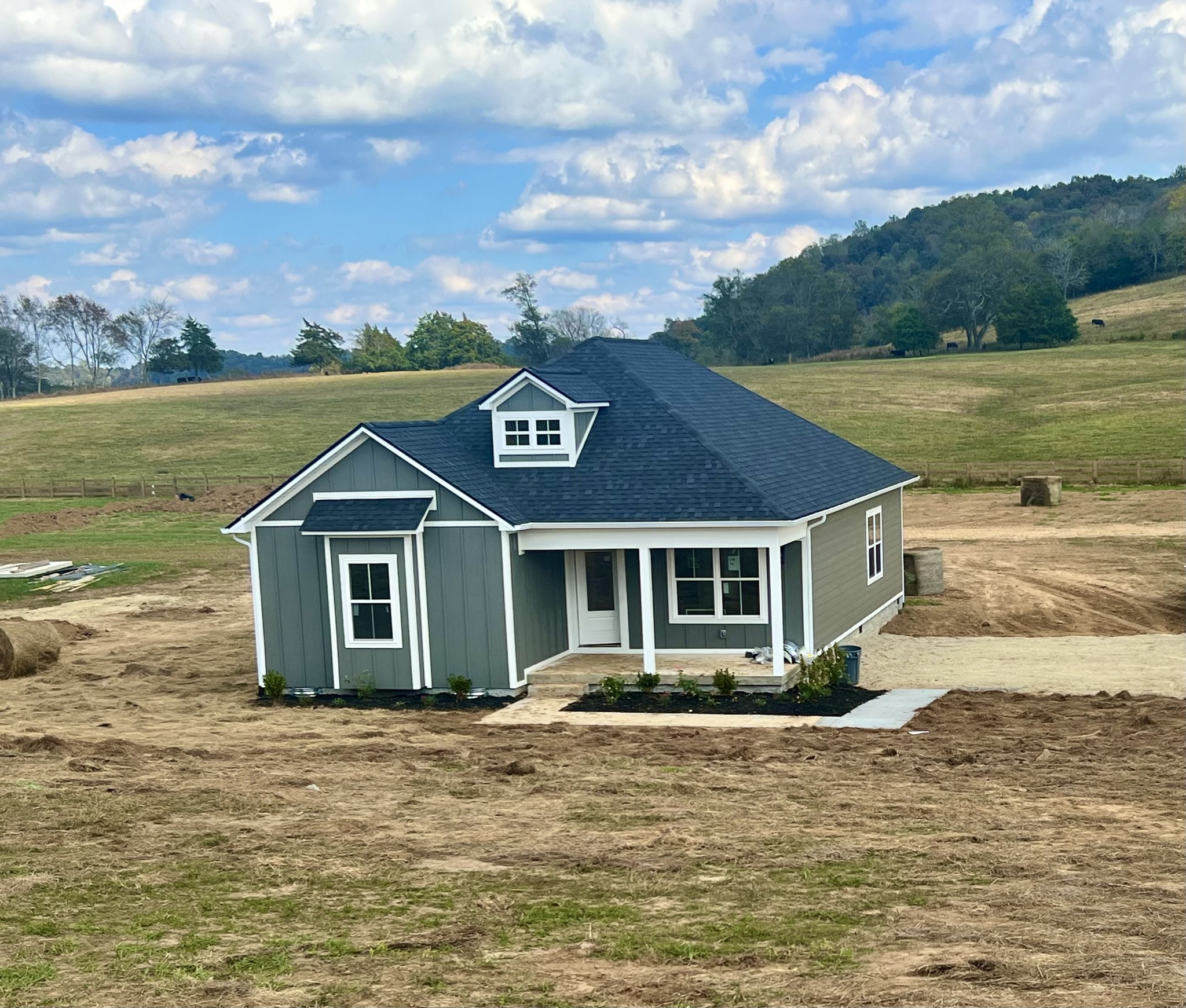 a front view of a house with a garden