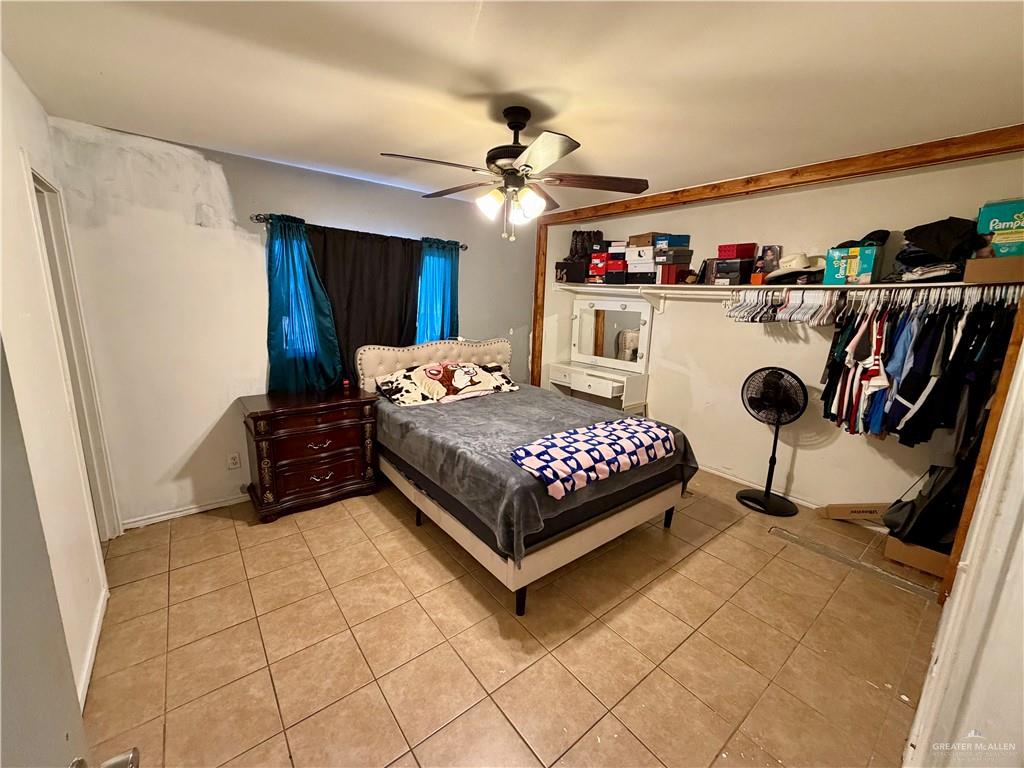 434 Serg Loop Alamo, TX 78516 - Photo 6 of 17 a bedroom with a bed and a chandelier