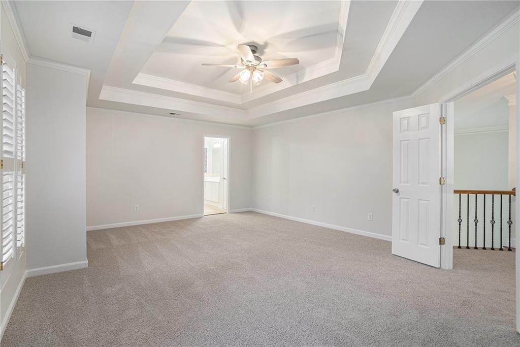 523 Sycamore Point Woodstock, GA 30189 - Photo 14 of 34 a view of an empty room with a ceiling fan