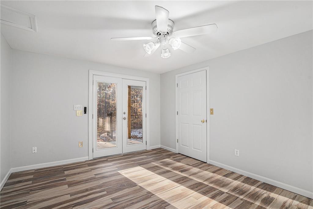 523 Sycamore Point Woodstock, GA 30189 - Photo 23 of 34 a view of a room with wooden floor and white walls