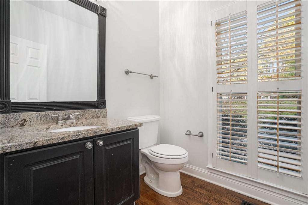523 Sycamore Point Woodstock, GA 30189 - Photo 26 of 34 a bathroom with a granite countertop sink toilet and mirror