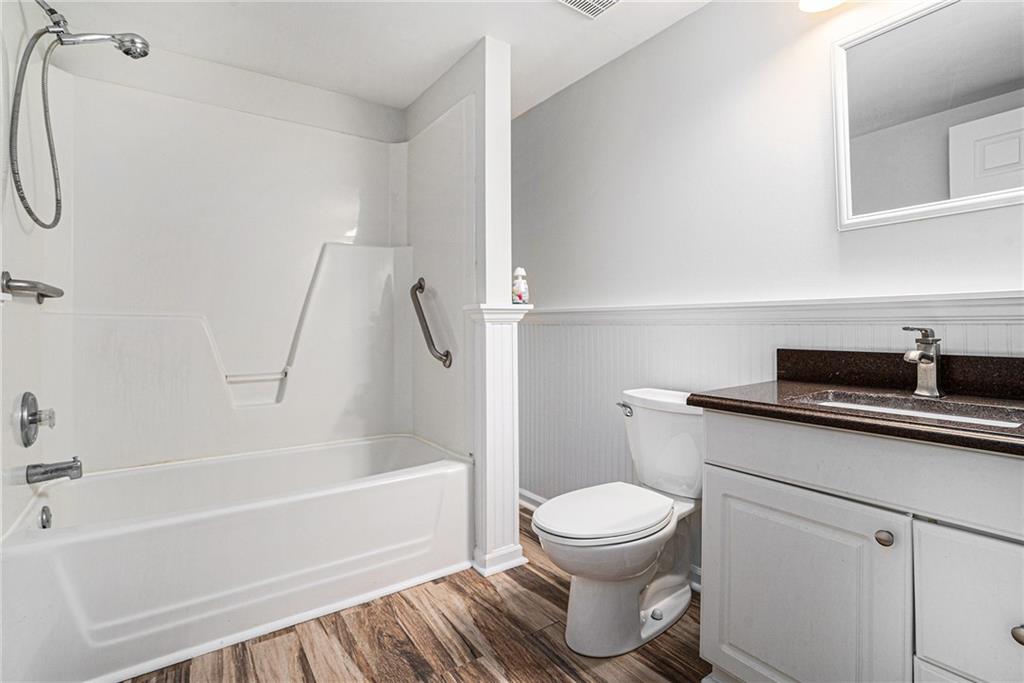 523 Sycamore Point Woodstock, GA 30189 - Photo 27 of 34 a bathroom with a sink a toilet and a bathtub