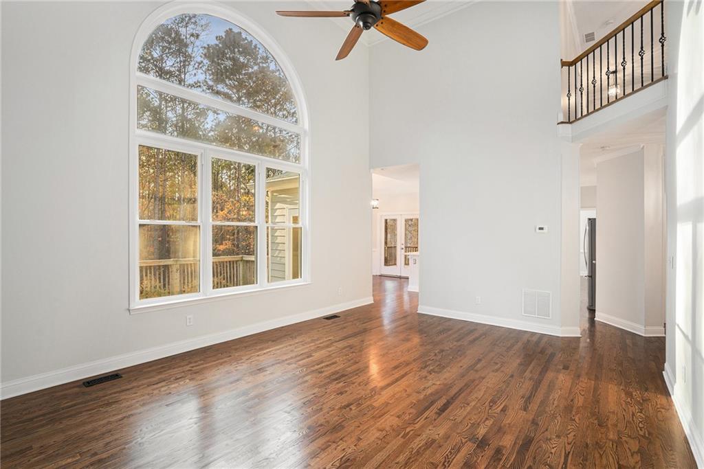 523 Sycamore Point Woodstock, GA 30189 - Photo 6 of 34 a view of an empty room with wooden floor and a window