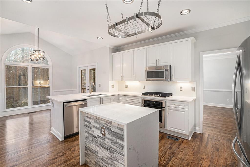523 Sycamore Point Woodstock, GA 30189 - Photo 9 of 34 a kitchen with a stove oven a refrigerator and a fireplace