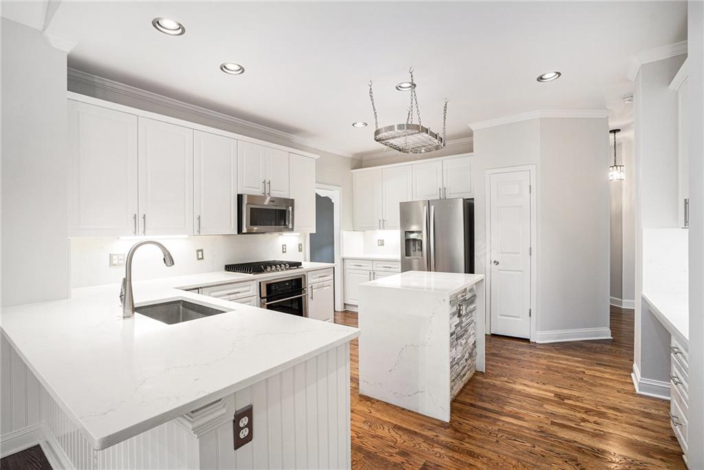 523 Sycamore Point Woodstock, GA 30189 - Photo 10 of 34 a kitchen with stainless steel appliances a stove refrigerator sink and microwave