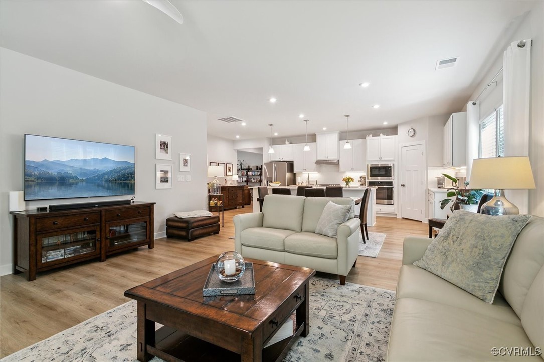 115 Apprentice Landing Williamsburg, VA 23185 - Photo 30 of 49 a living room with furniture a kitchen view and a fireplace