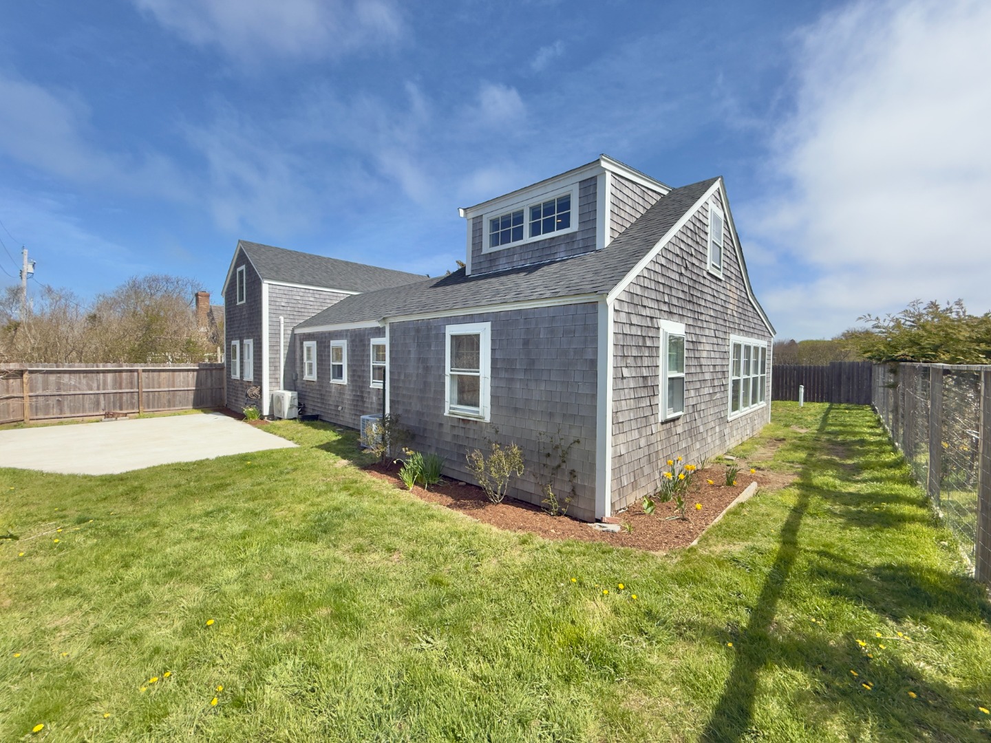 1 H Street Nantucket, MA 02554 - Photo 1 of 18 a view of backyard with a garden and entertaining space