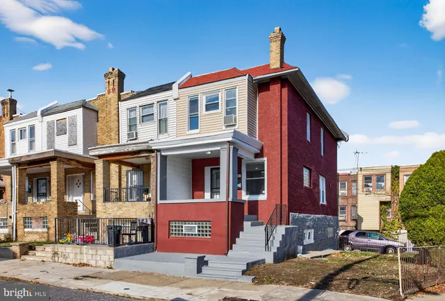 a front view of a house with a street