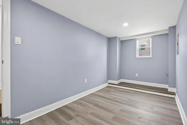 a view of room with wooden floor