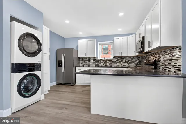 a view of a kitchen with washer and dryer