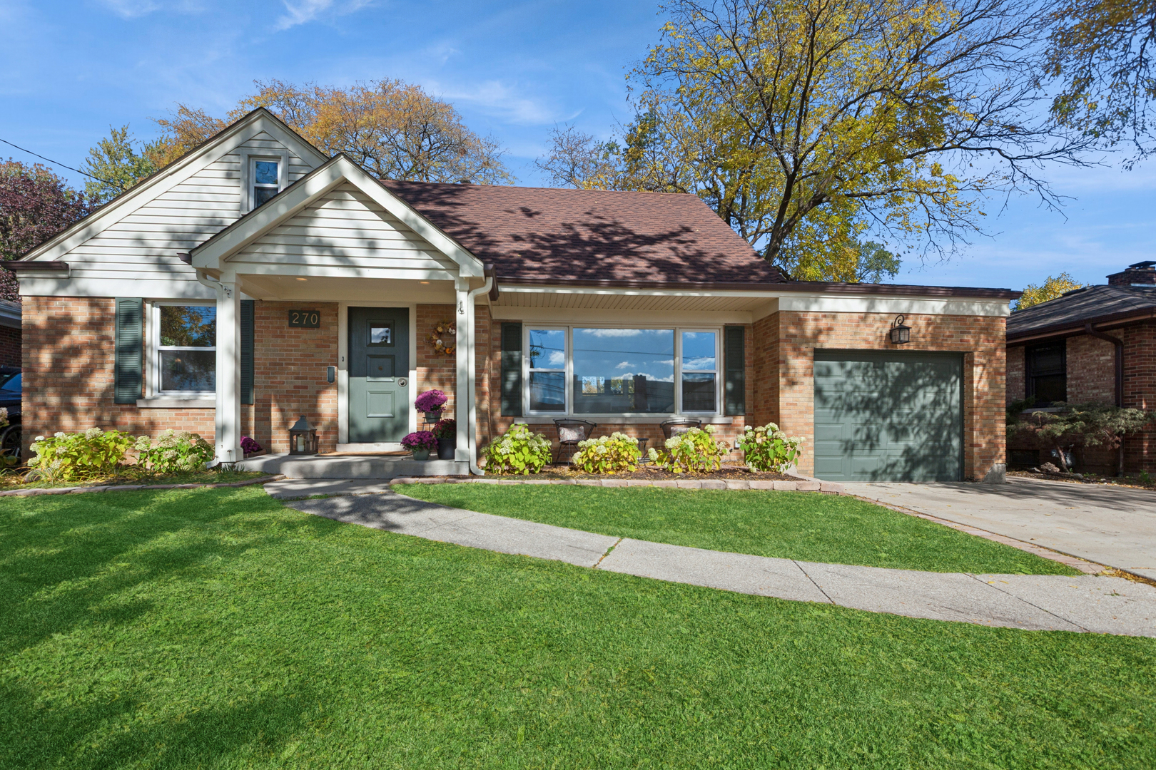 270 Hawthorne Boulevard Glen Ellyn, IL 60137 - Photo 1 of 34 a front view of a house with a yard table and chairs
