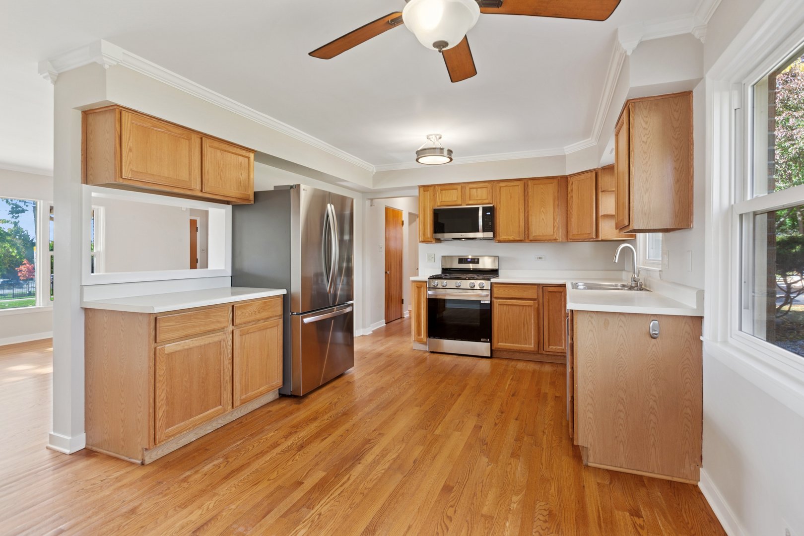 270 Hawthorne Boulevard Glen Ellyn, IL 60137 - Photo 12 of 34 a kitchen with granite countertop wooden floors stainless steel appliances and window