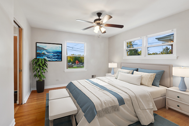 270 Hawthorne Boulevard Glen Ellyn, IL 60137 - Photo 15 of 34 a bedroom with a bed and a chandelier