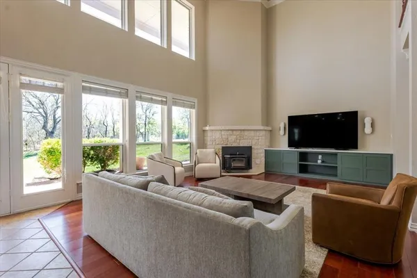a living room with furniture a flat screen tv and a fireplace