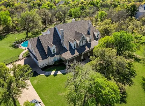 an aerial view of a house with big yard