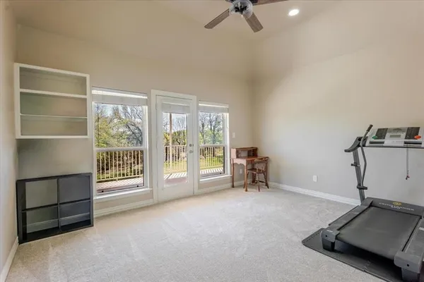 a spacious bedroom with a bed and wooden floor