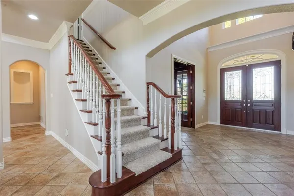a view of entryway and hall with a front door
