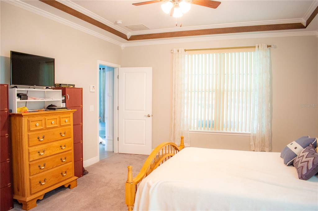 17993 Gourd Neck Loop Winter Garden, FL 34787 - Photo 11 of 29 a bedroom with a bed and a flat tv screen on dresser