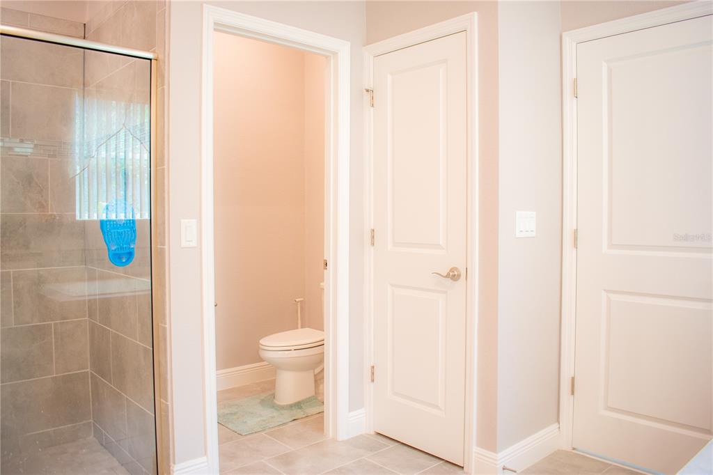 17993 Gourd Neck Loop Winter Garden, FL 34787 - Photo 14 of 29 a bathroom with a shower and a toilet