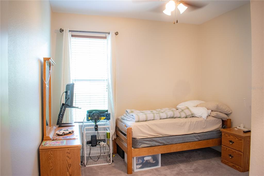 17993 Gourd Neck Loop Winter Garden, FL 34787 - Photo 19 of 29 a bedroom with a bed and a window